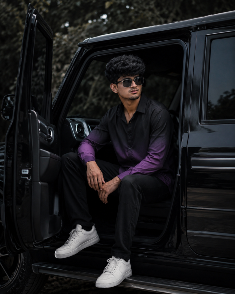 Cinematic portrait of a stylish man sitting in a black SUV with a moody background.